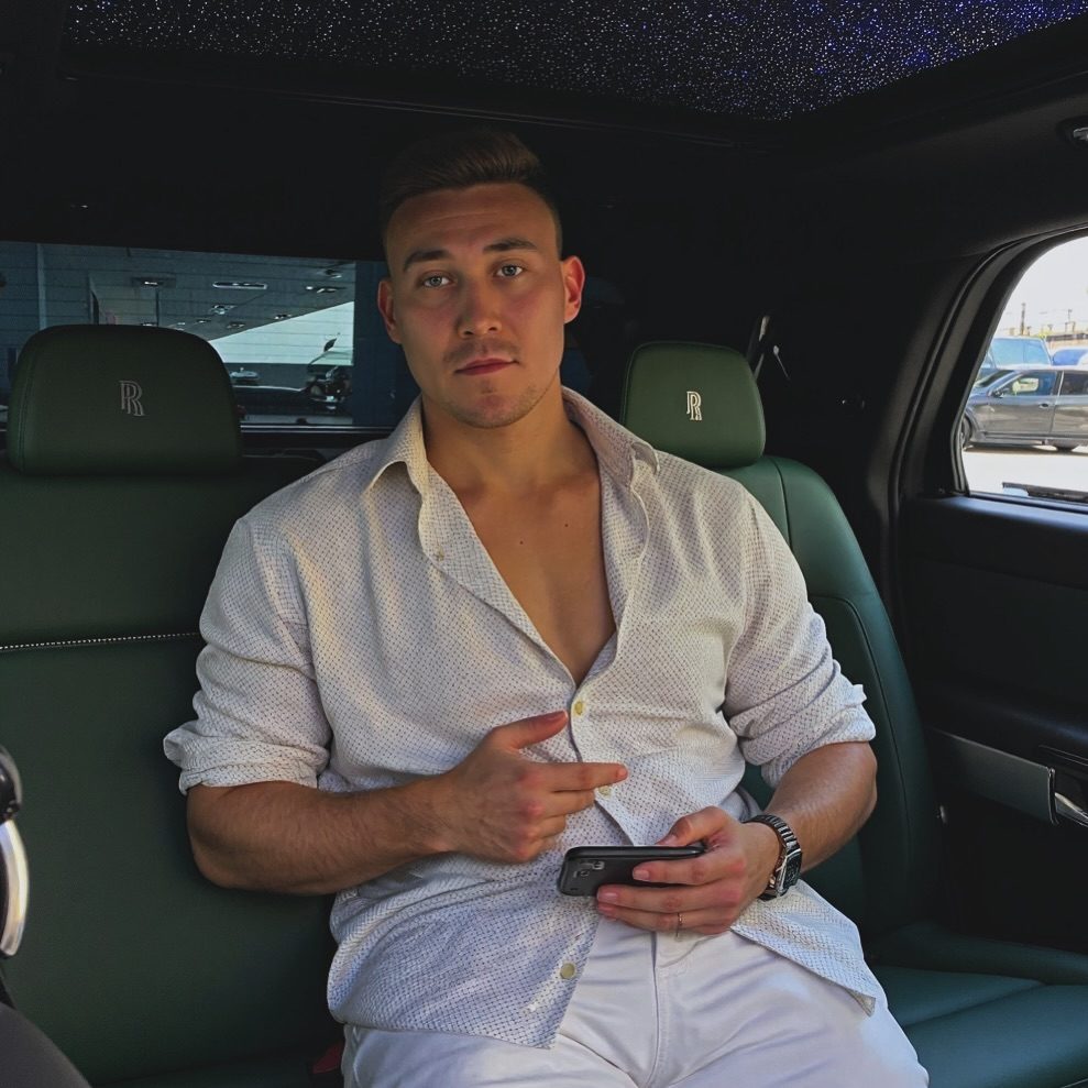 Portrait of Arthur seated in a car interior with a starlight roof